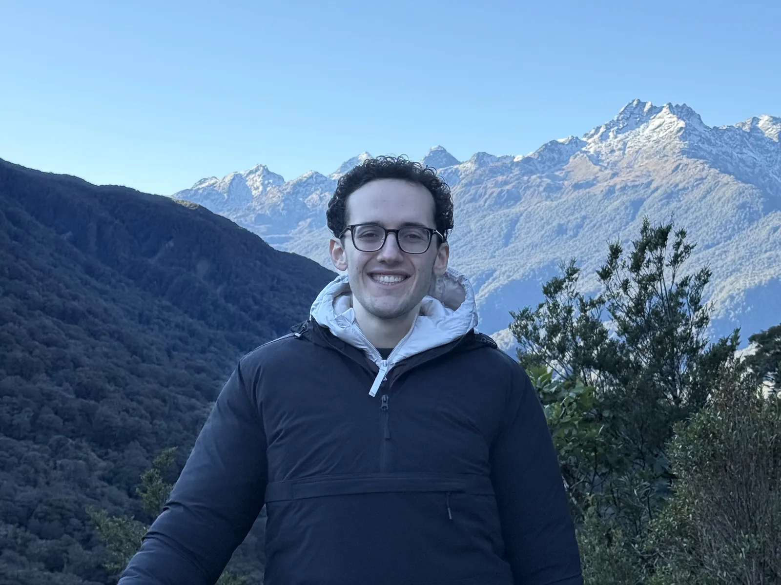 Steven Winnick in front of a snow-capped mountain range