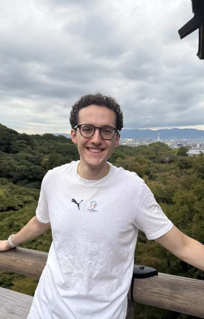 Steven Winnick on a hillside overlook above a city
